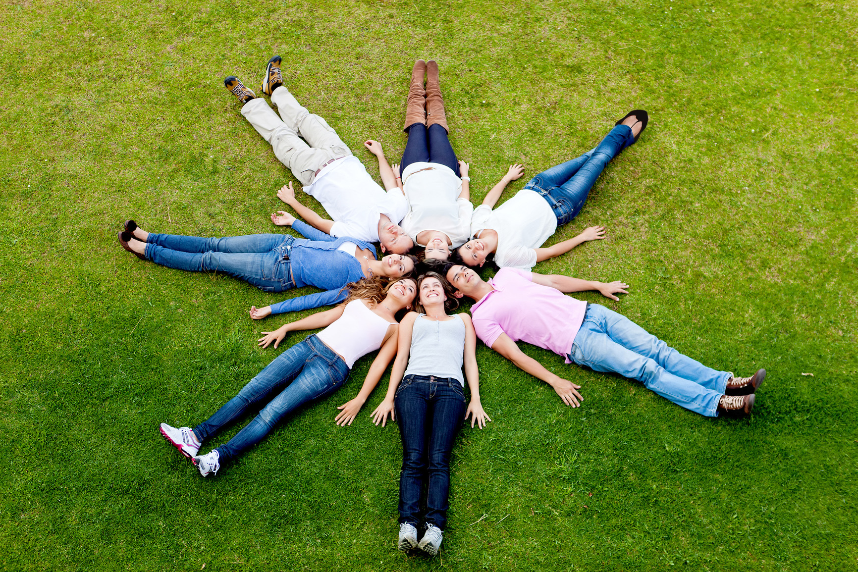 Group of people laying in a circle