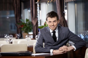 Portrait of the smiling business man at restaurant