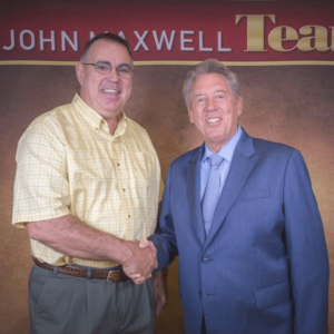Caz shaking hands with John Maxwell